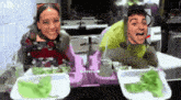 a man and a woman sit at a table with plates of food