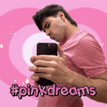 a man in a pink shirt is taking a selfie with the hashtag #pinkdreams on the bottom