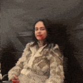 a woman in a fur coat with blood on her face
