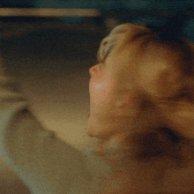 a woman is screaming with her mouth open