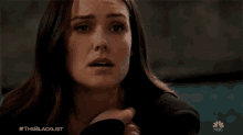 a close up of a woman 's face with the hashtag #theblacklist