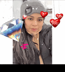 a woman wearing a gray hat and a black jacket with hearts that say love you