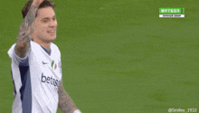 two soccer players are giving each other a high five on a green screen that says futbol 1