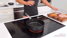 a frying pan is cooking on a stove with the words made in animatica above it