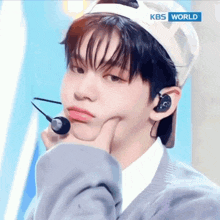 a close up of a person 's face with kbs world in the corner