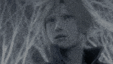 a black and white image of a person with a turtleneck