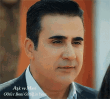 a close up of a man 's face with the words aşk ve mavi on the bottom right