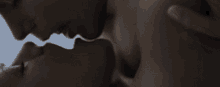 a close up of a man and woman kissing each other