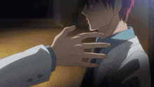 a man 's hand is touching another man 's neck