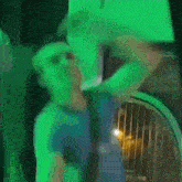 a blurry picture of a man standing in front of a green wall