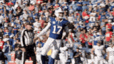 a buffalo bills player wearing number 17 stands on the field