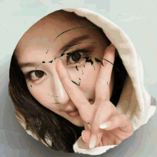 a woman is making a peace sign with her hands