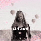 a woman in a black top with the name lili ana written on it