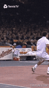 a tennis player is running on a court in front of a sign that says " alteroder "