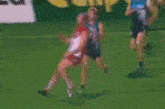 a group of people are playing soccer on a field and one of them is wearing a jersey that says lg