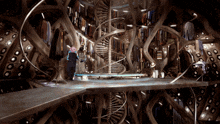 a man in a hat stands in a very large room