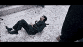 a man in a suit and tie is laying on a tiled floor