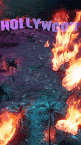 a hollywood sign is on fire with palm trees in the background
