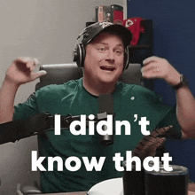 a man wearing headphones and a green shirt says i did n't know that