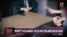 a tln news report shows a man shaking hands with a woman