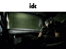 a video game character is sitting in the back seat of a car with the word idc below him