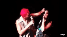 a blurry picture of a man and a woman on a stage with the words rbd.gif on the bottom