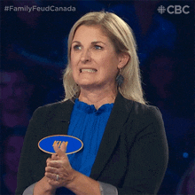 a woman wearing a black jacket and a blue shirt has a name tag that says kim