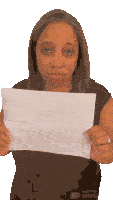a woman in a black shirt is holding a piece of paper that says made with unsplash
