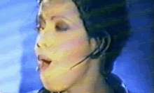 a close up of a woman wearing a headset while singing