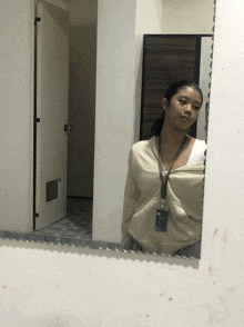 a woman taking a picture of herself in the mirror