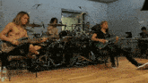a man playing a guitar in front of a drum set that says pearl on it