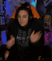 a woman wearing headphones and a black shirt that says sleep