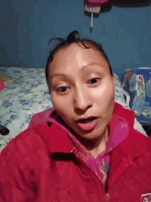 a woman wearing a red jacket with the letter f on it