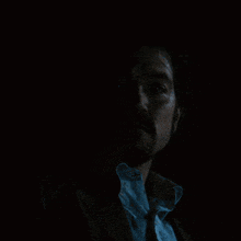 a man with a beard is pointing at the camera