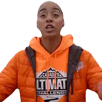 a woman wearing an orange hoodie that says canada 's ultimate challenge on it