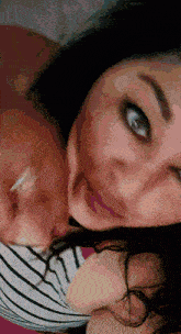 a close up of a woman 's face with a blurred background
