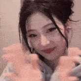 a young woman is making a heart shape with her hands .
