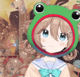a girl wearing a green frog hat with a red circle around it