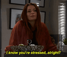 a woman says i know you 're stressed alright in front of a bowl