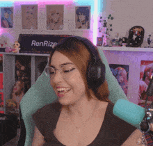 a woman wearing headphones is smiling in front of a renrize sign