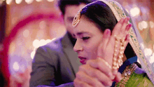 a man is holding a woman 's hand while they dance