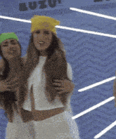 a woman wearing a yellow headband is standing next to another woman wearing a green headband
