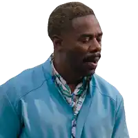 a man with a blue jacket and a scarf around his neck looks at the camera