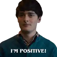 a man in a blue sweater with the words i 'm positive on the bottom