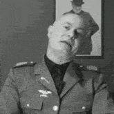 a man in a military uniform has a small eagle on the sleeve