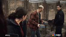 a nbc ad shows people feeding dogs in a kennel