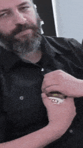 a man with a beard is holding a jar of star