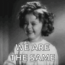 a black and white photo of a little girl with the words `` we are the same '' written on it .