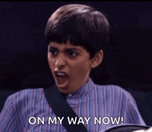 a young boy with his mouth open and the words on my way now