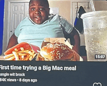 a video of a boy eating a hamburger and french fries